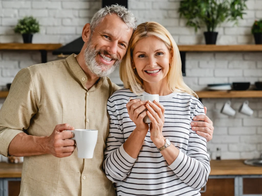 couple smiling after dental implants deep river, CT