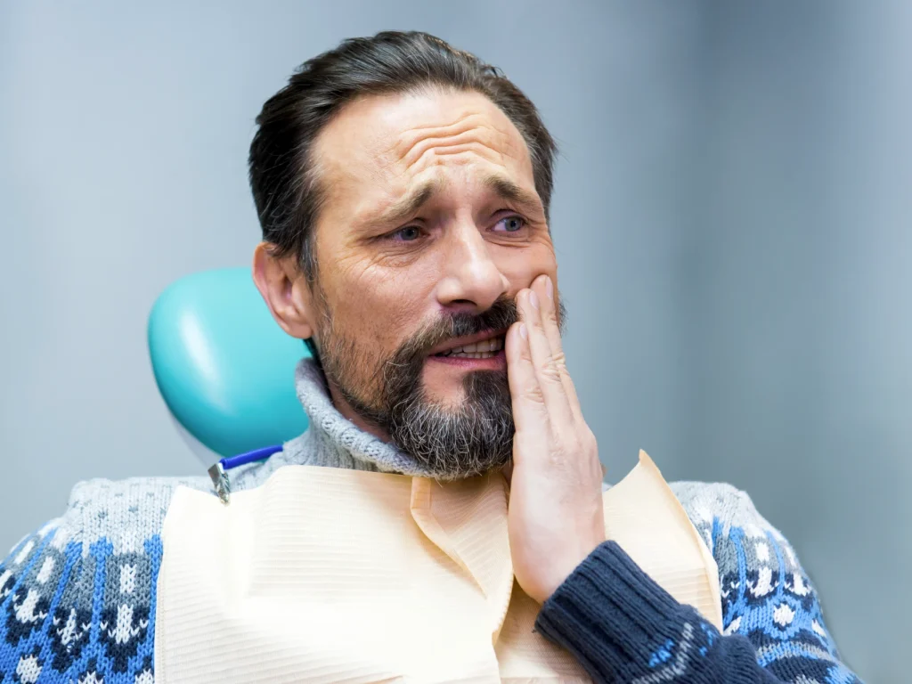 man with tooth pain | emergency dentist Monroe, CT